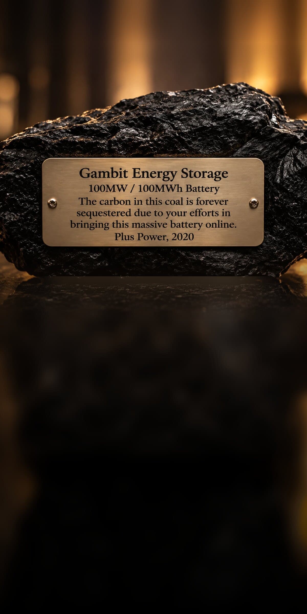 A lump of coal with a Plus Power plaque for the 100 MW Gambit Energy Storage battery, 2020